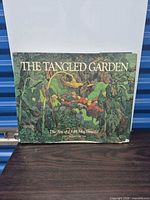 Front view of The Tangled Garden art book with dust jacket