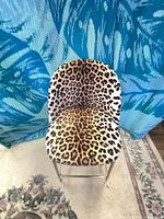 Front view of leopard print upholstered bar stool