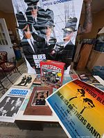 Group shot showing Blues Brothers posters, Three Stooges VCR Game, Abbott & Costello booklets and other ephemera