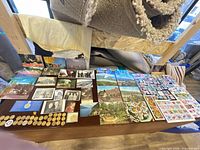 Overall view of postcards, photos, stamps and tokens spread on table