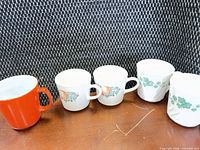 all five mugs lined up showing patterns and colors
