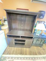 Front view showing full structure: TV compartment, open shelf, lower cabinet