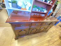 Front angled view showing drawers, doors, brass hardware