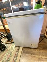 Front view of Kenmore chest freezer showing exterior condition and dents