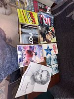 Group shot of all magazines, portrait print and photos on table