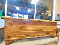 Front and side view of cedar blanket chest showing wood grain and feet