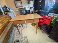 Full view of desk showing single drawer and tapered legs