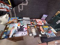 Overview of all magazines and DVD spread out on furniture surface