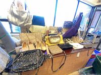 Overview of all handbags, shoes and belts on table