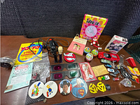 Overall lot layout showing all toys, controller, pins and books
