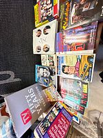 Top-down view of entire lot showing books and magazines spread on table