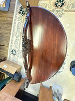 Top view showing demi-lune shape, mahogany finish, rope edge carving