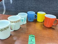All six mugs lined up showing patterns and colors