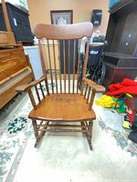 Front view of solid wood Windsor spindle back rocking chair