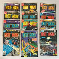 All twelve Batman issues laid out, some in plastic sleeves showing covers and issue numbers