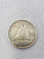 Reverse showing Bluenose schooner, legends CANADA 1942 10 CENTS