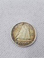 Reverse of 1947 Canadian dime showing Bluenose schooner, denomination and toning