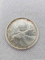 Reverse of 1965 Canadian 25-cent coin showing caribou and date