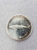 Reverse showing mackerel, denomination and centennial dates