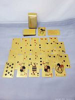 Deck spread showing multiple gold cards, box, certificate