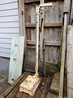 Full view of cast iron medical scale showing height rod and platform