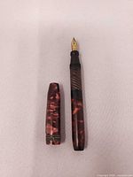Pen disassembled showing barrel and cap