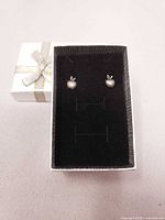 Pair of pewter apple stud earrings in open gift box