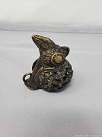 Front angled view of bronze bird figurine