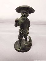 front view of bronze fisherman statuette