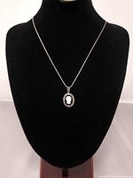 Front view of pendant on chain displayed on bust