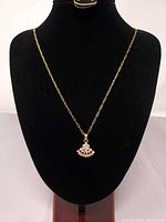 Full view of necklace on display bust showing chain length and pendant