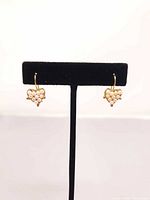 Front view of both earrings on display stand