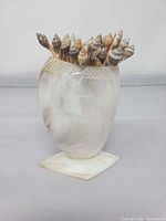 Full view of mother-of-pearl stand filled with shell-tipped skewers