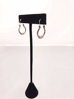 Earrings displayed on stand showing shape and design