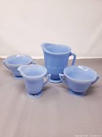 Group shot of all four robin's egg blue Pyrex pieces