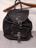 Front view showing flap, buckles, texture