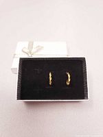 Closed gift box with earrings displayed inside