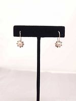 front view of earrings on display stand