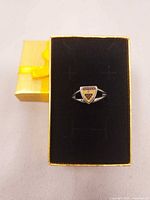Ring displayed in gift box showing crest