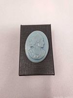 Blue oval cameo on black textured gift box