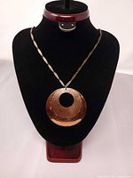 Full view of copper necklace on display bust