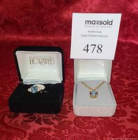 Ring and necklace in their presentation boxes