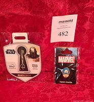 Both sealed pins: Star Wars Mandalorian key pin and Marvel Captain America pin