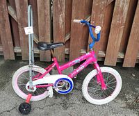 Left side view of pink Avigo 16" bicycle with training wheels