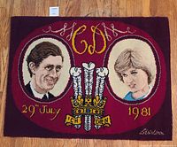 Full view of commemorative rug showing portraits, crest, date, monogram