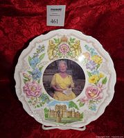 Front view showing portrait, floral design, crest and castle illustration