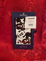 Front of boxed Swarovski phone cover showing Mickey Mouse design through window