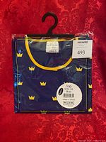 Front view of packaged blue Swedish crown t-shirt on hanger
