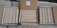Three open cartons showing full sets of beige rounded trim tiles