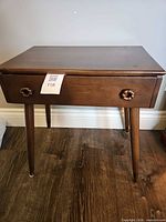 Stained brown veneer single-drawer cabinet table on tapered legs